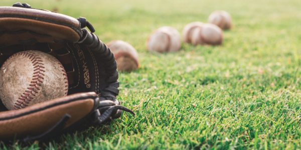 white baseball ball on brown leather baseball mitt