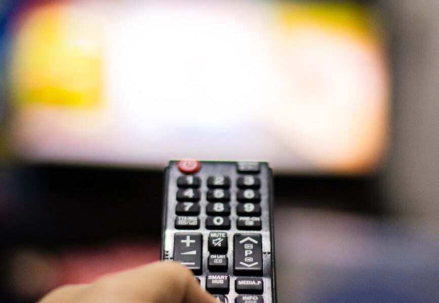 person holding black remote control