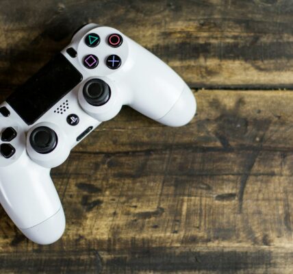 white gaming console on wooden surface